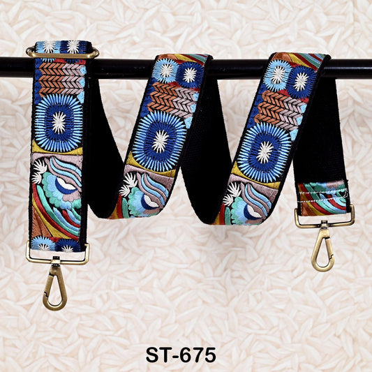 A colorful, patterned strap with a metallic buckle, hanging on a black bar.