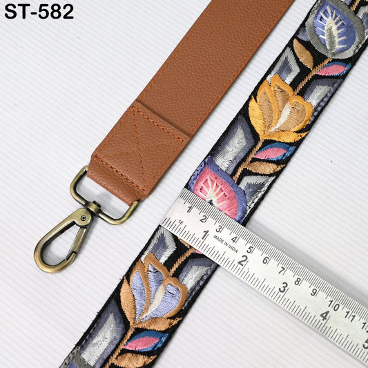 a brown leather strap with a floral pattern and a metal ruler placed next to it, indicating the strap's length.