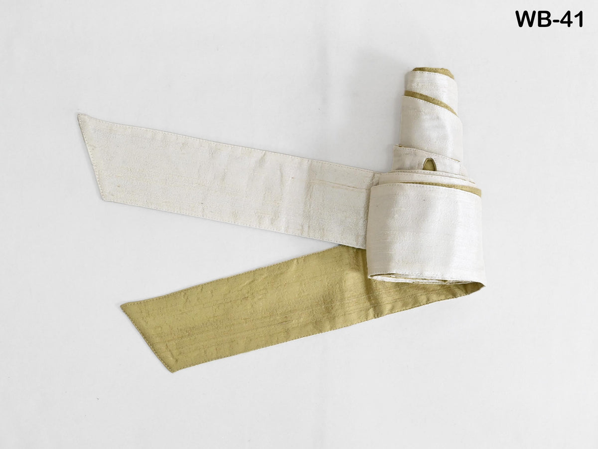 a white and gold fabric item, possibly a piece of clothing or a decorative accessory, with a gold stripe or pattern on it.