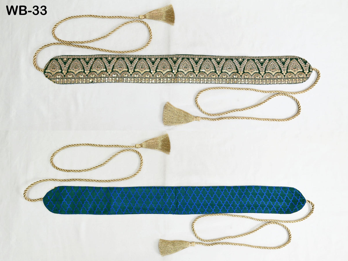 two decorative items with tassels, one in a blue color and the other in a green color, both placed on a white surface.