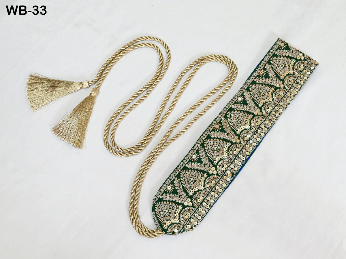 a decorative piece with a gold tassel and a green and gold patterned fabric. The tassel has two gold tassels attached to it, and the fabric has a repeating pattern of green and gold designs. The piece appears to be a decorative accessory, possibly a scarf or a headband.