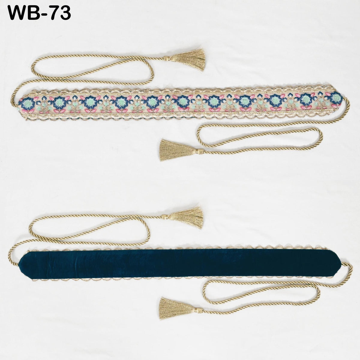 two decorative fabric pieces, one with a blue velvet-like texture and the other with a gold velvet-like texture, both featuring intricate floral patterns. The pieces are tied with gold tassels, adding an elegant touch to their design.