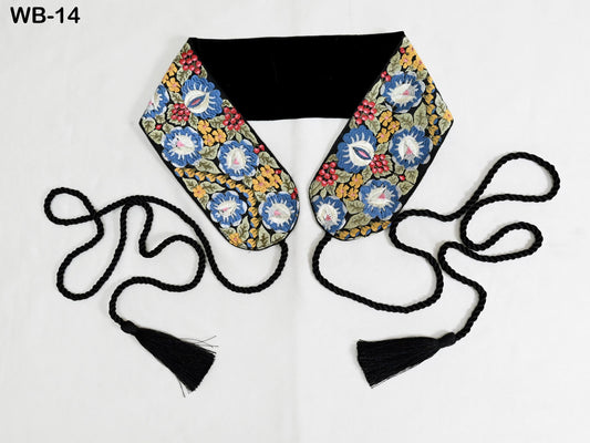 A colorful, floral-patterned scarf with black tassels, displayed on a white background.