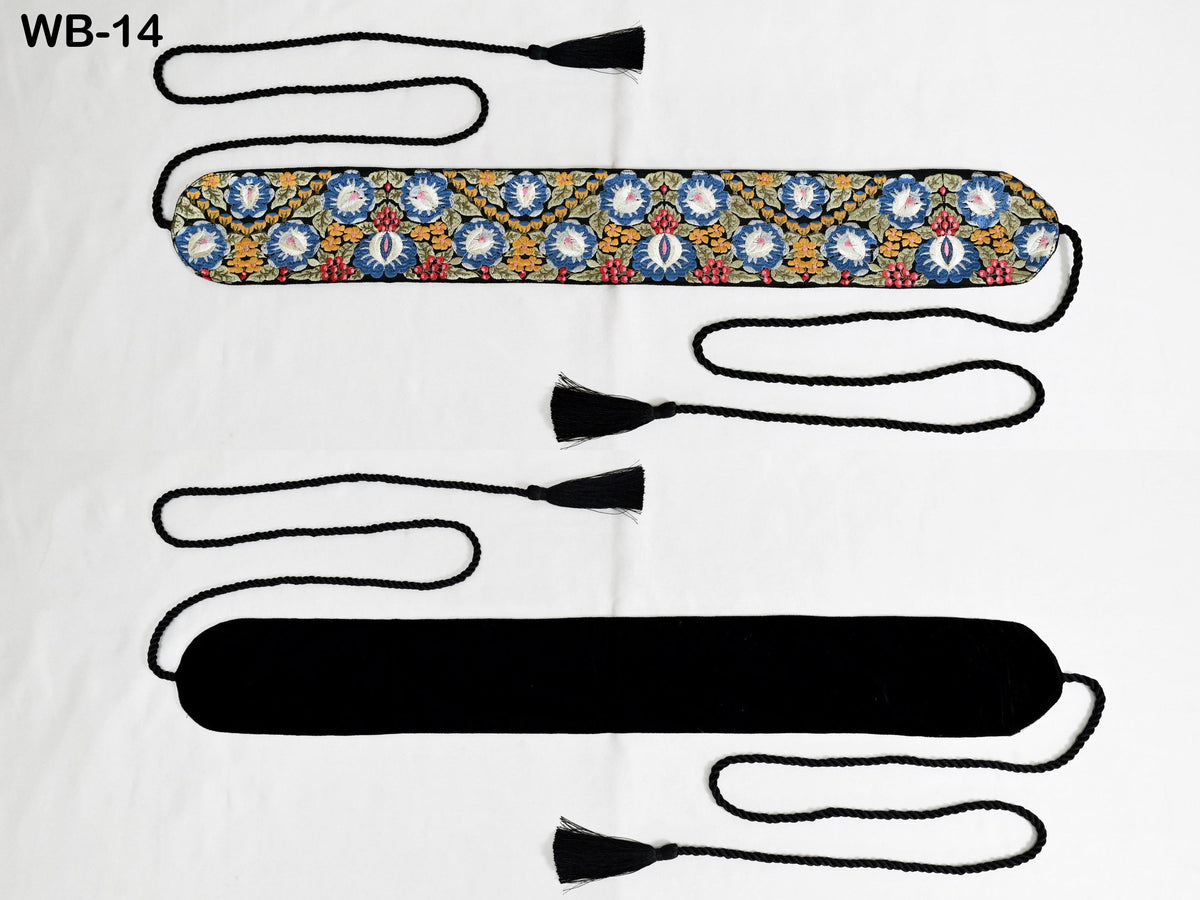 two decorative items, one with a floral pattern and the other with a black tassel. The items are displayed against a white background, and there are two black strings attached to them.