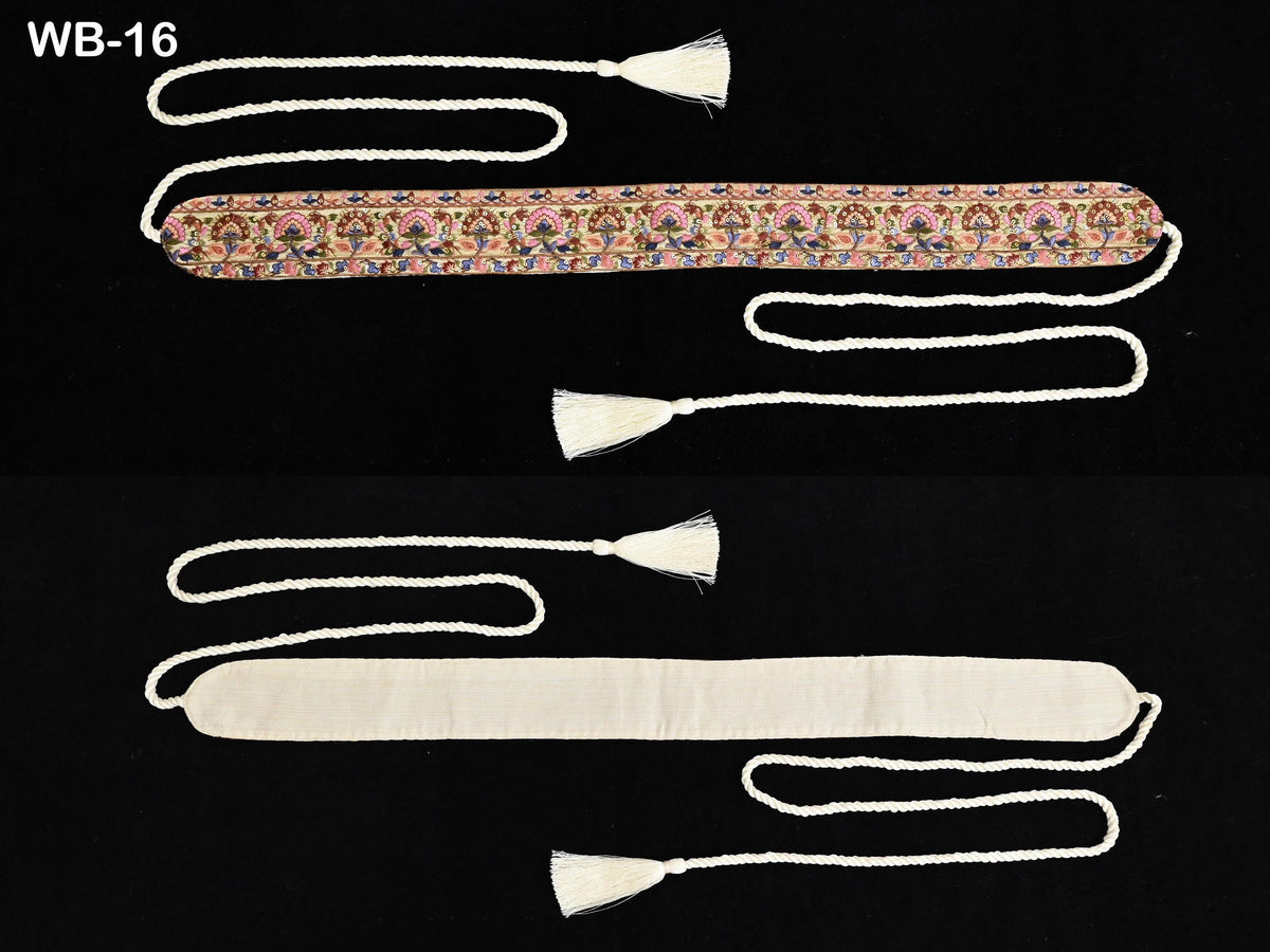 two pieces of fabric with tassels, one with a floral pattern and the other with a solid color.