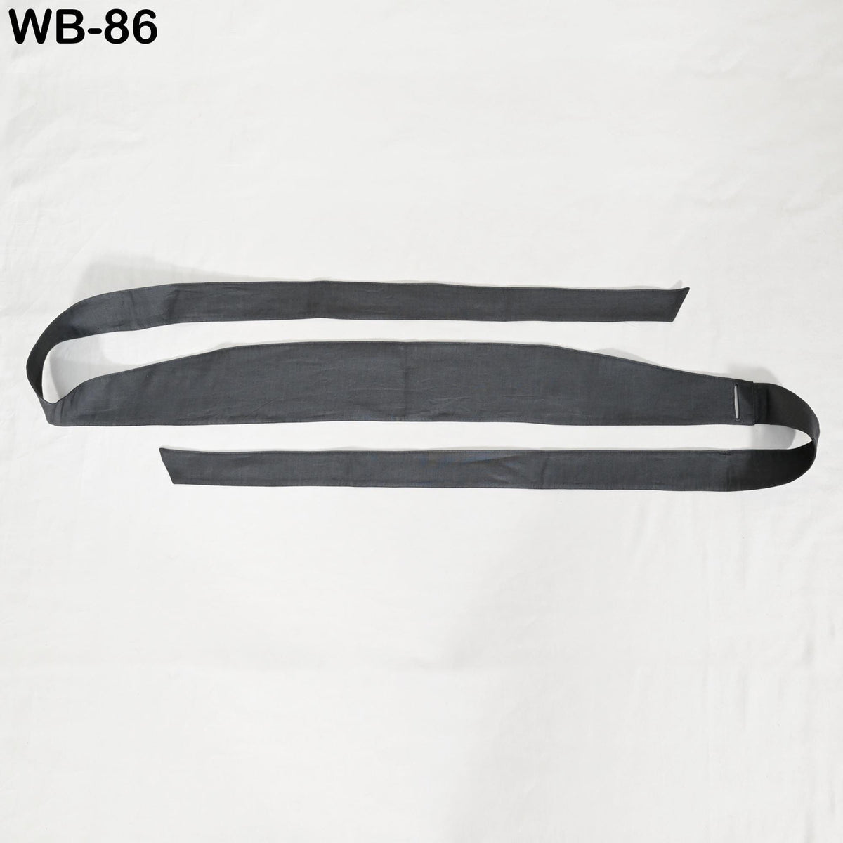 a pair of black straps or belts laid out on a white background.