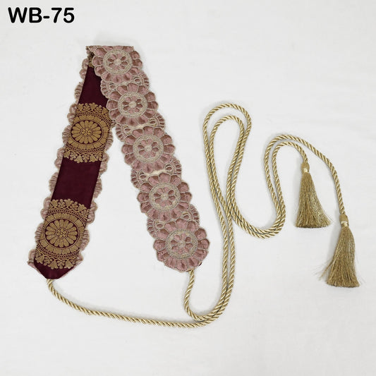 A decorative piece with a floral pattern on a burgundy background, featuring a gold tassel and a gold rope.
