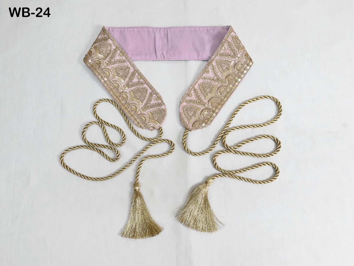 a decorative accessory with a pink fabric band and gold tassels, arranged on a white background.