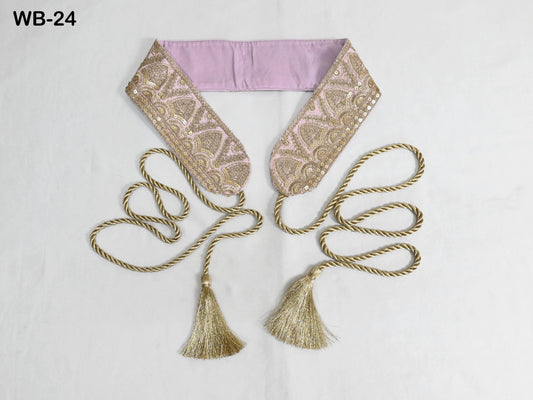 a decorative accessory with a pink fabric band and gold tassels, arranged on a white background.