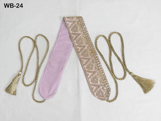 a decorative pink and gold sash with tassels, placed on a white background.