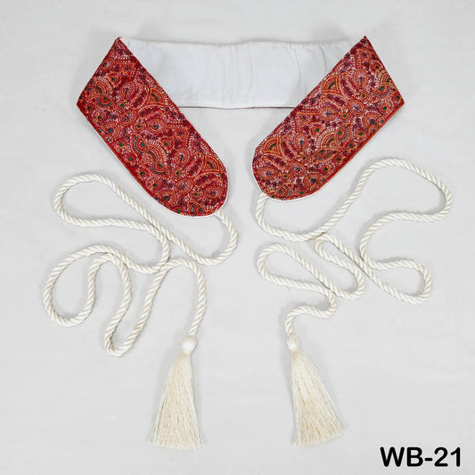 a pair of decorative red and white tassels attached to a white fabric, with a white rope or cord extending from the tassels.