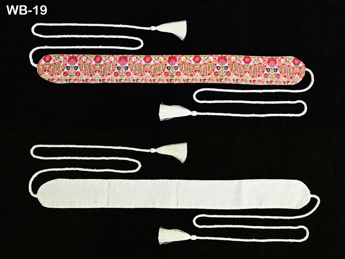 two white tassels attached to a black background, one with a floral pattern and the other with a solid color.