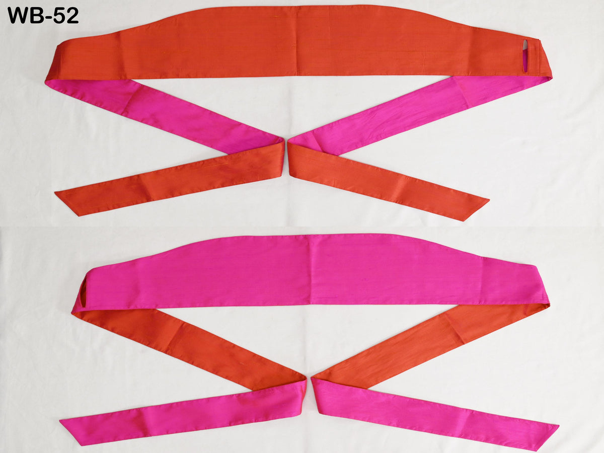 two colorful fabric ribbons, one in a bright red color and the other in a vibrant pink color, arranged in a visually appealing manner.