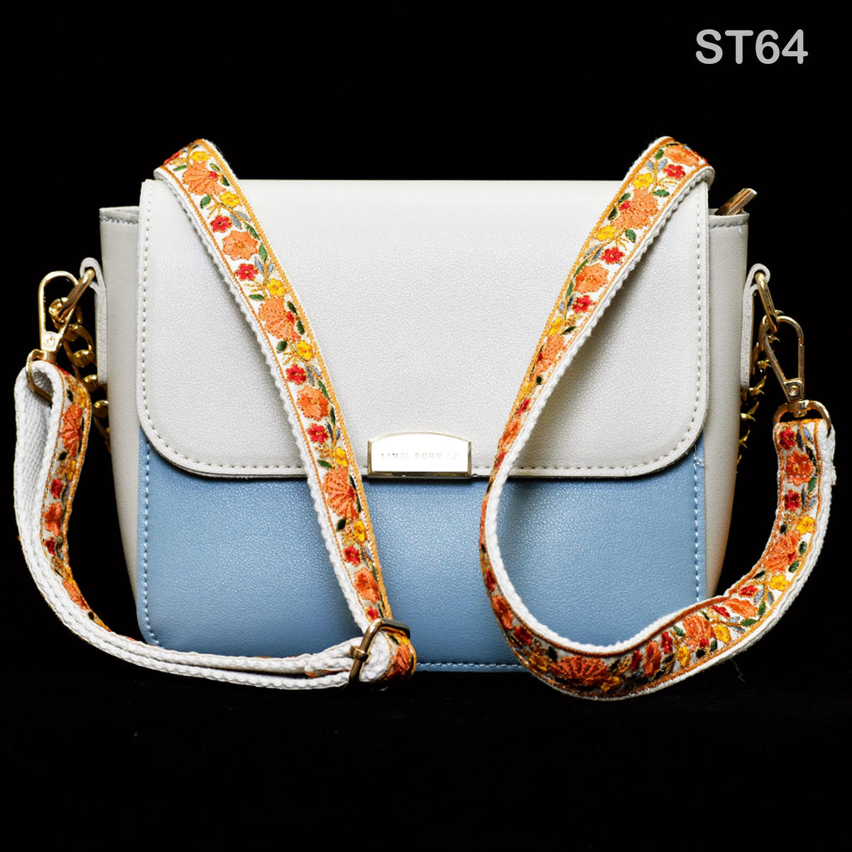 A white and blue handbag with a floral patterned strap, displayed against a black background.