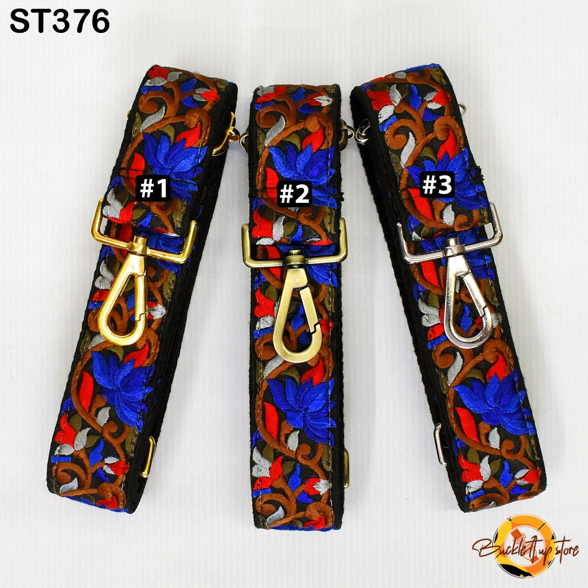 Three colorful straps with floral patterns, each with a gold-colored metal clasp and a black metal loop.