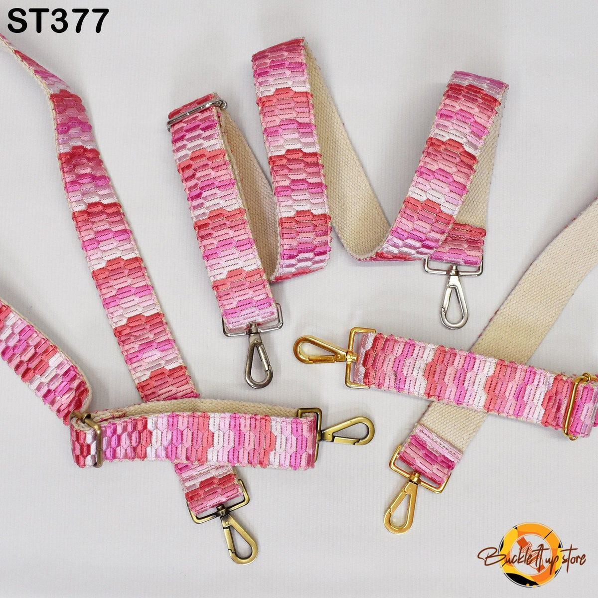 a collection of colorful, patterned straps with metal hooks, arranged on a white background.