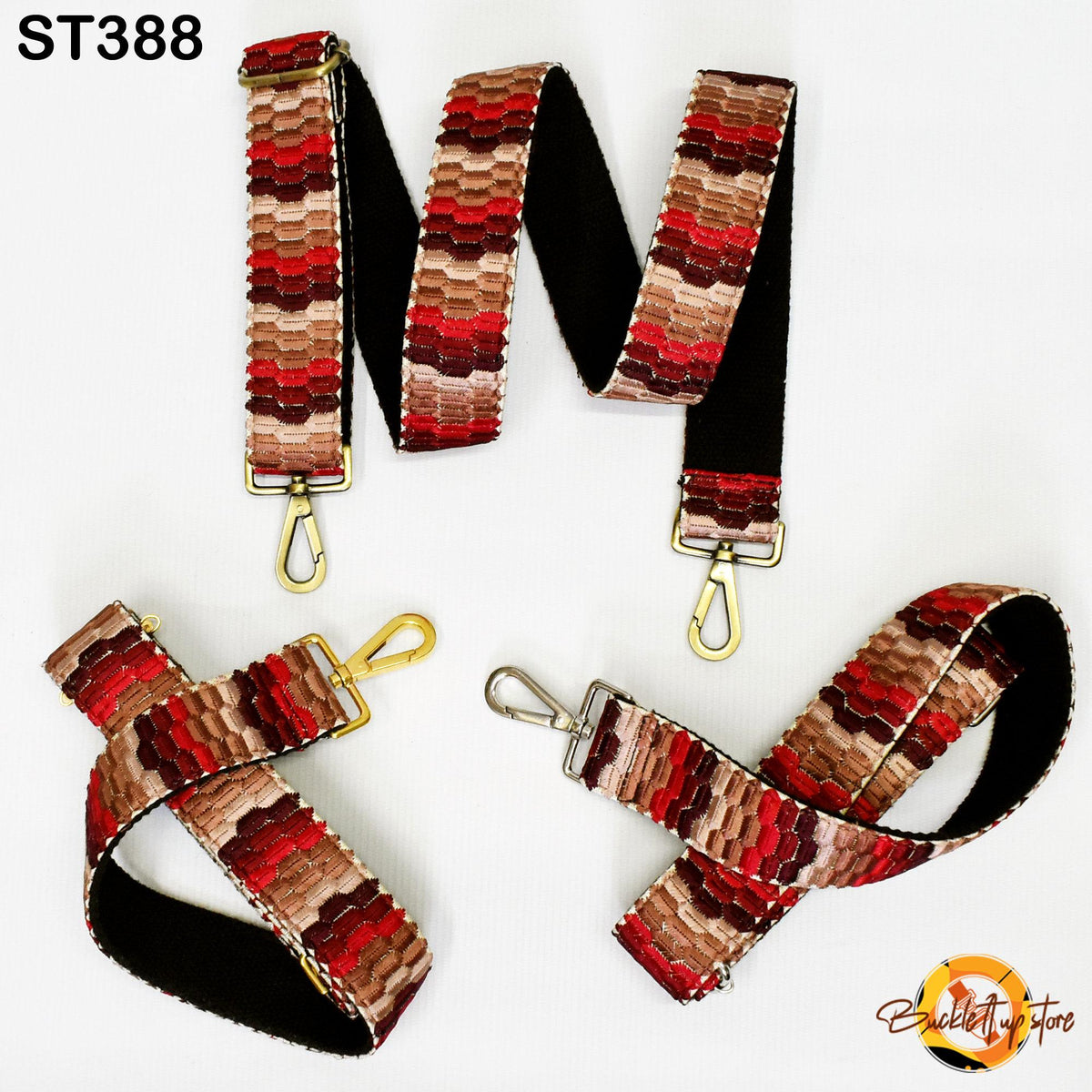 a collection of colorful, patterned straps with gold hardware, including a black strap with a gold hook and loop, a red and brown striped strap with a gold hook and loop, and a red and brown striped strap with a gold hook and loop.