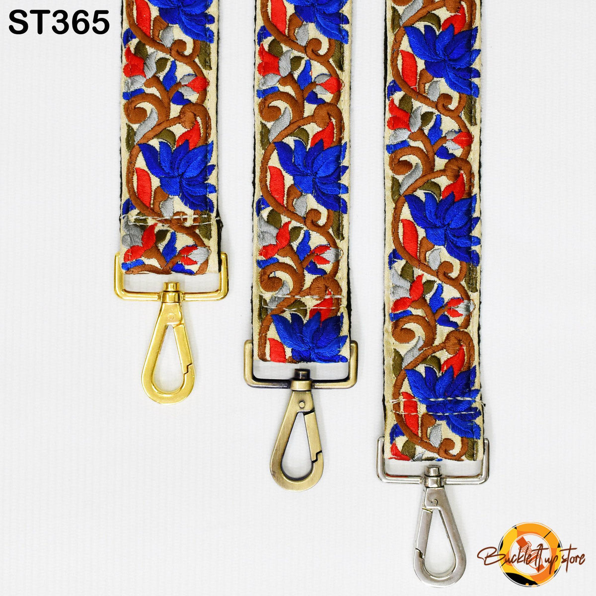 three colorful straps with floral patterns in blue, red, and gold. The straps have metal hooks and buckles, suggesting they are designed for use as a crossbody bag strap.