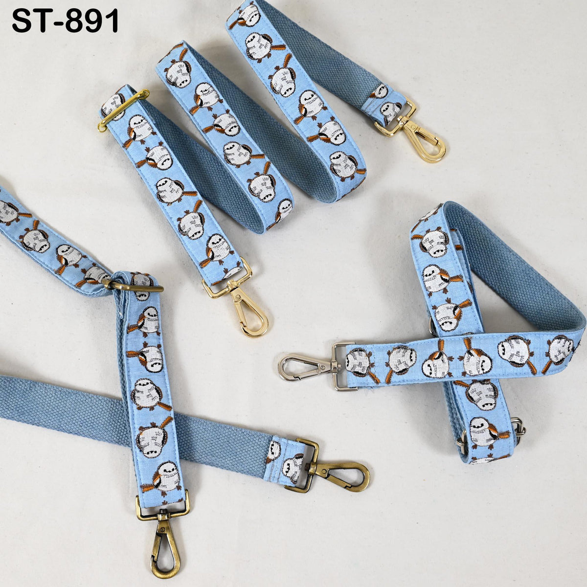 a collection of blue straps with a repeating pattern of cartoon-like bird faces, likely representing a brand or product design.