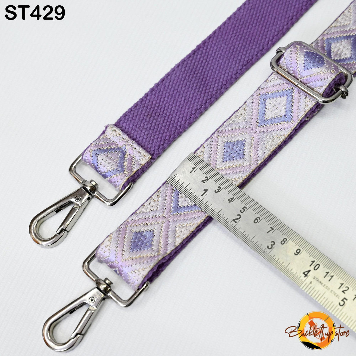 a purple strap with a metal clasp and a ruler placed next to it, indicating the strap's size.
