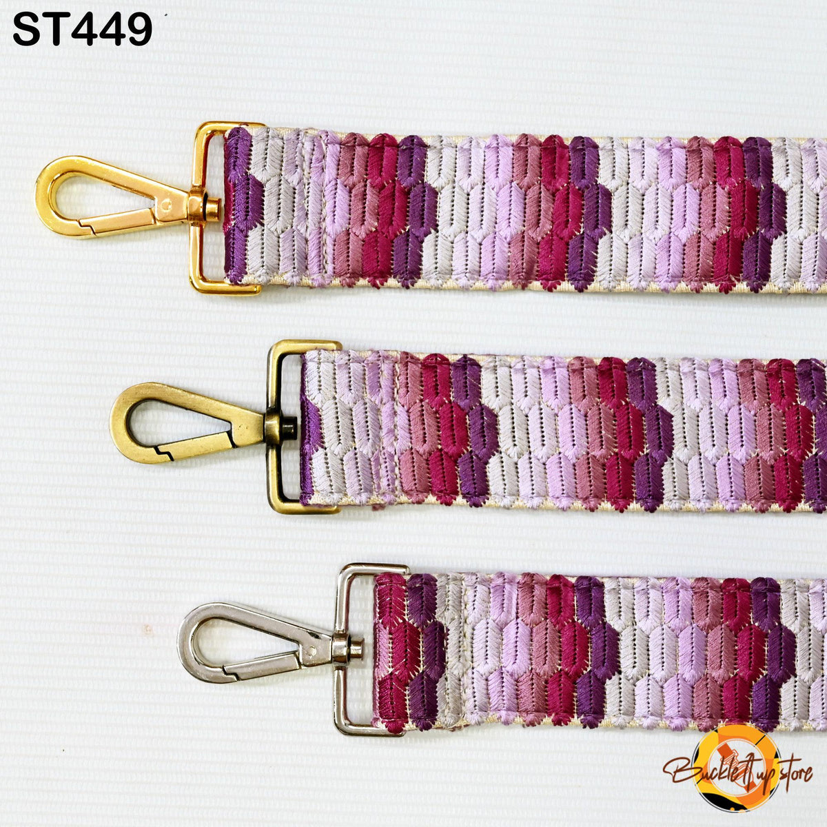 three colorful straps with gold buckles, arranged in a row.