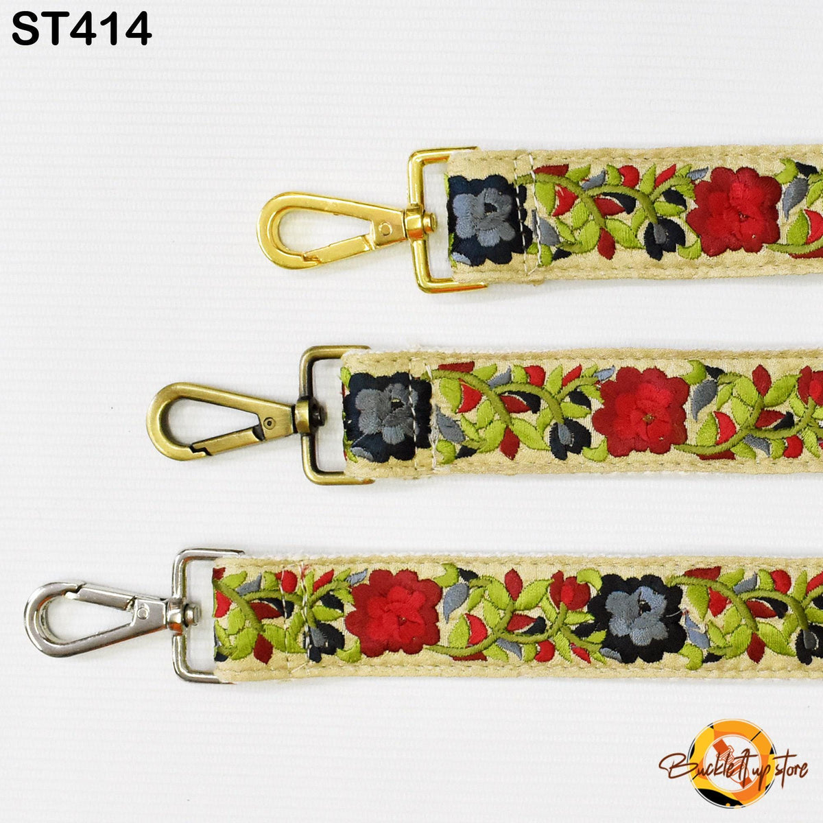 three different straps with floral embroidery, each featuring a metal clasp and a metal hook.