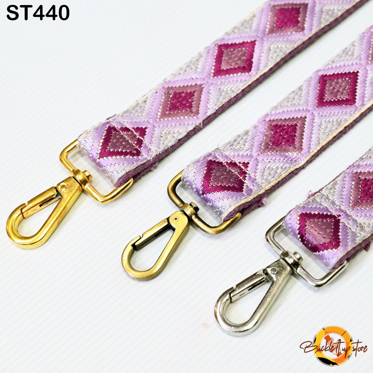 three colorful straps with metal hooks, arranged side by side.