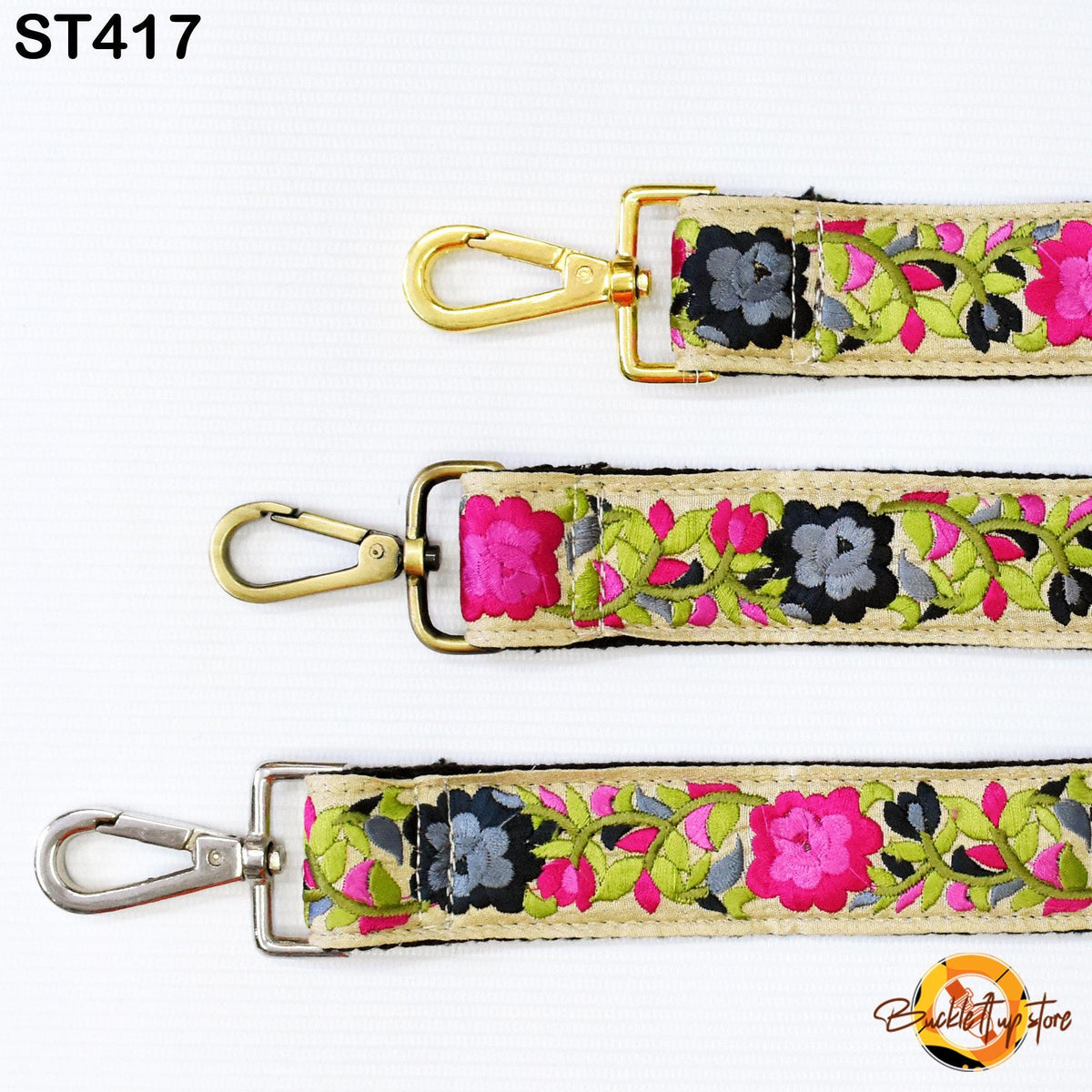 three different straps with floral patterns in pink, green, and black colors. The straps appear to be made of fabric and have metal hooks or buckles attached to them.