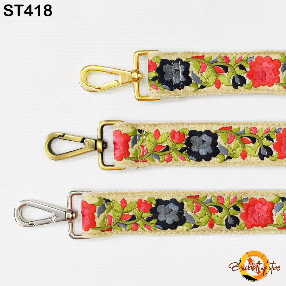 three different straps with floral embroidery, each with a metal clasp and hook.