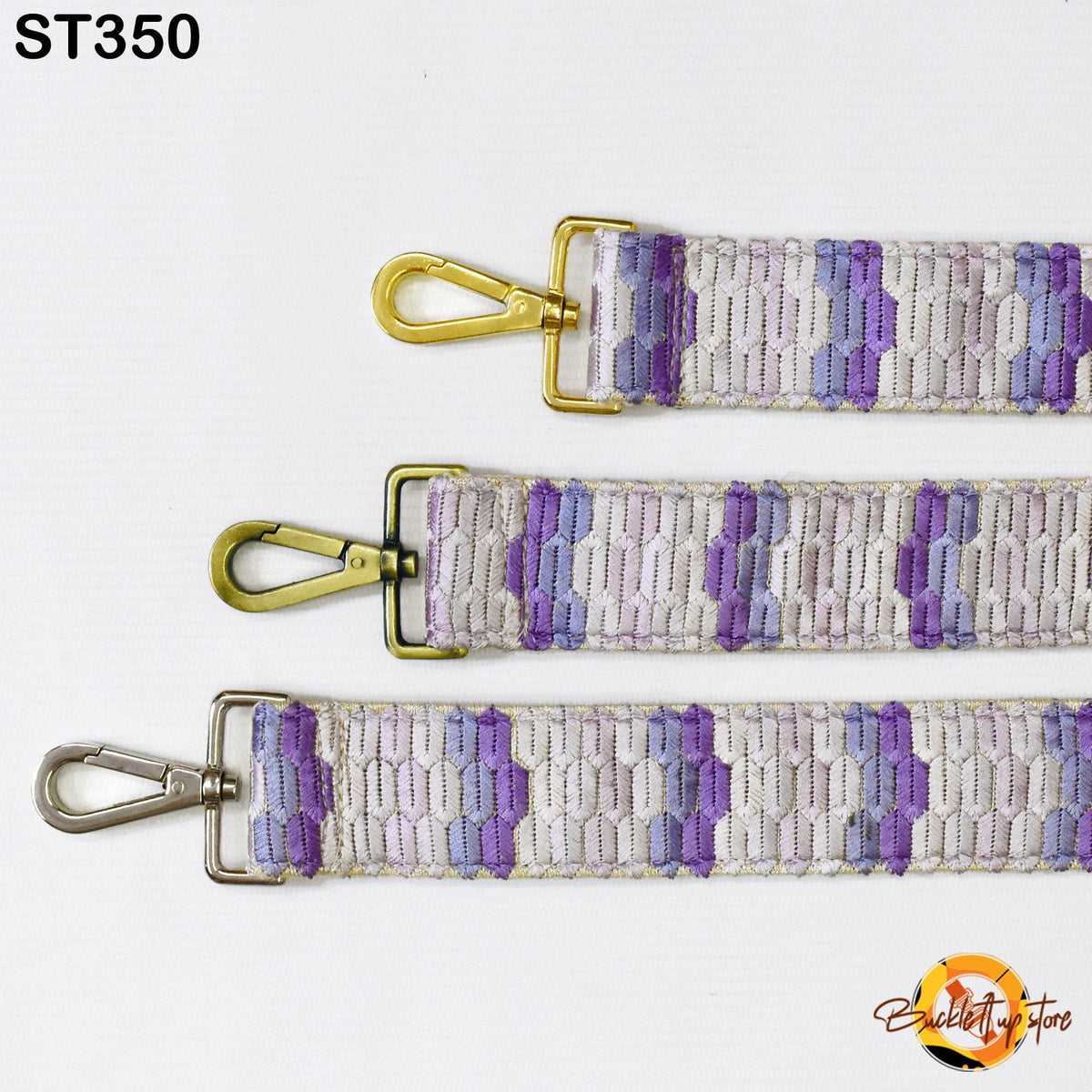 three straps with different patterns of purple and gray stripes. The straps have metal hooks and are attached to a white background.