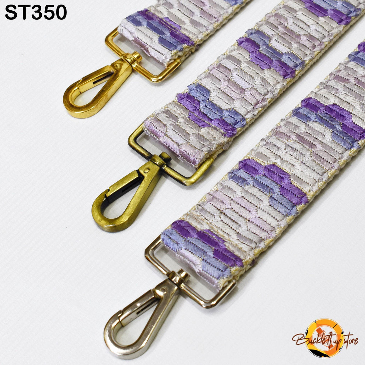 three different straps with metal hooks and buckles, arranged side by side.