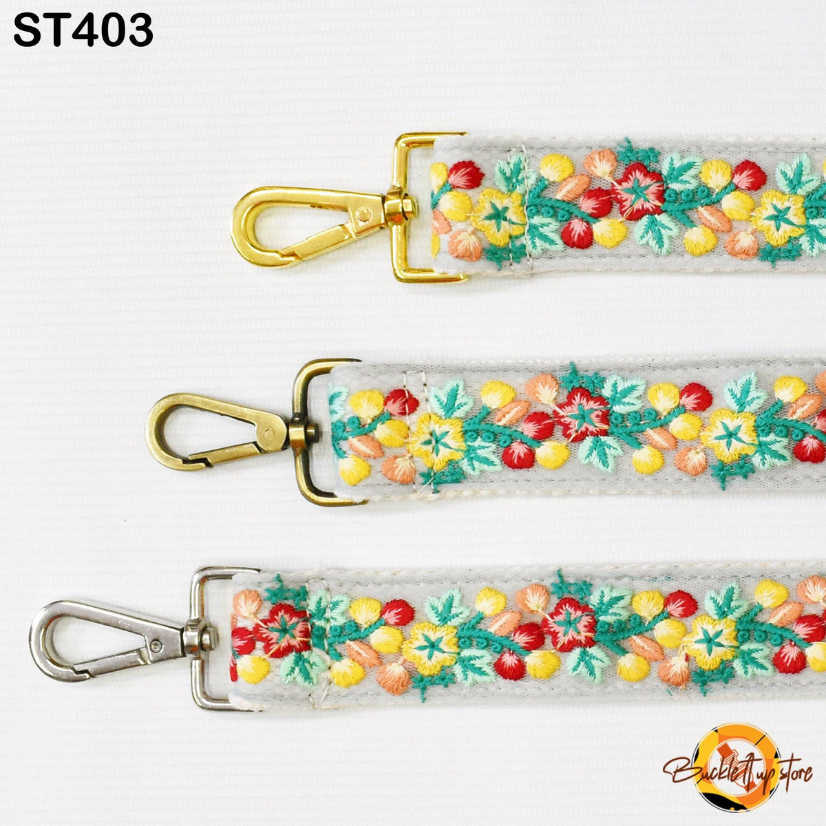 three different straps with floral embroidery, each with a gold metal clasp.
