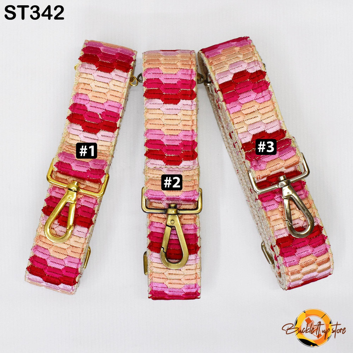 three colorful straps with different patterns, each with a metal clasp and a small label indicating the strap number.