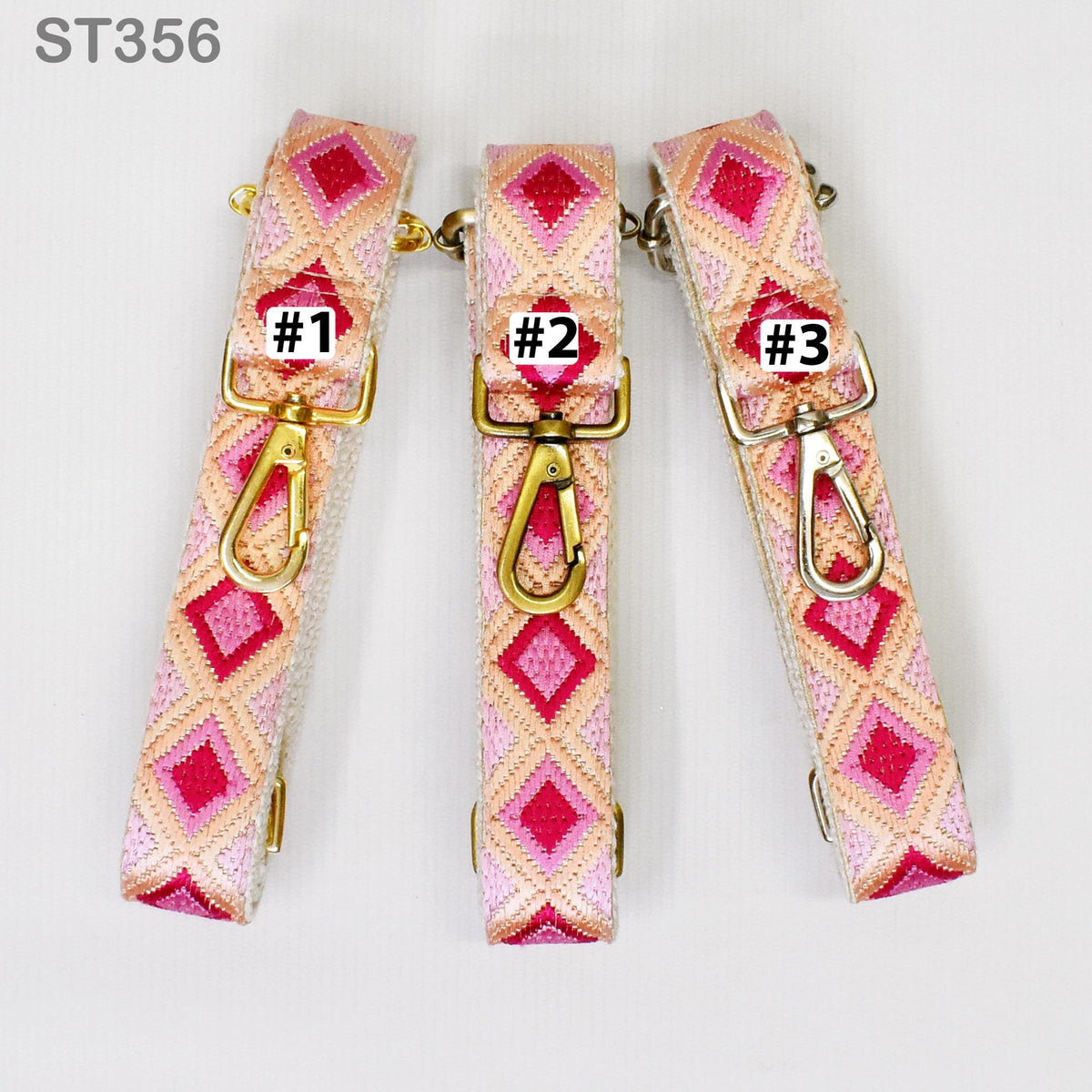 Three colorful straps with a diamond pattern, each with a metal clasp and a small tag with a number printed on it.