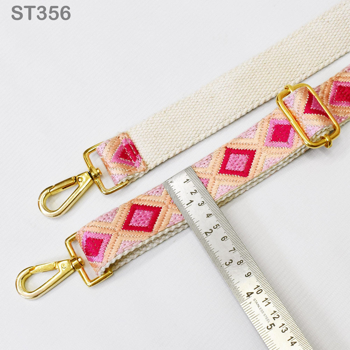 a strap with a pink and orange diamond pattern, and a ruler is placed next to it, indicating the strap's size.