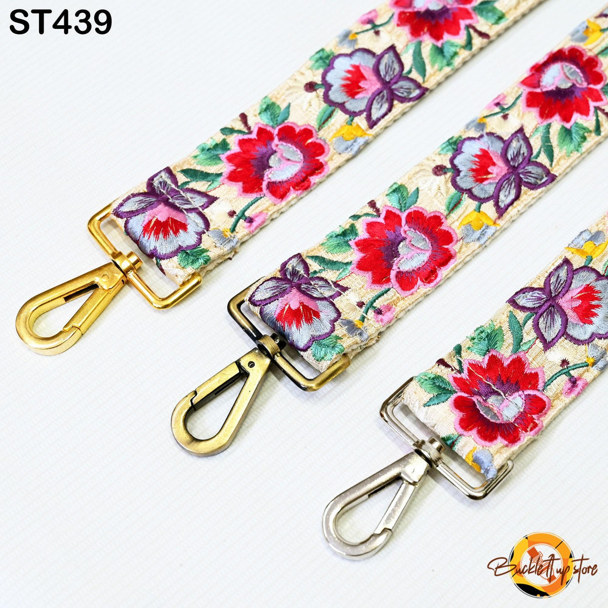 three colorful straps with floral patterns, each featuring a gold-colored metal clasp.