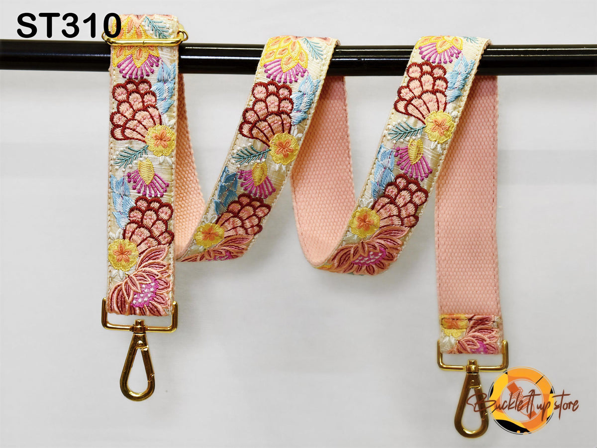 a pair of colorful floral straps hanging on a black bar.