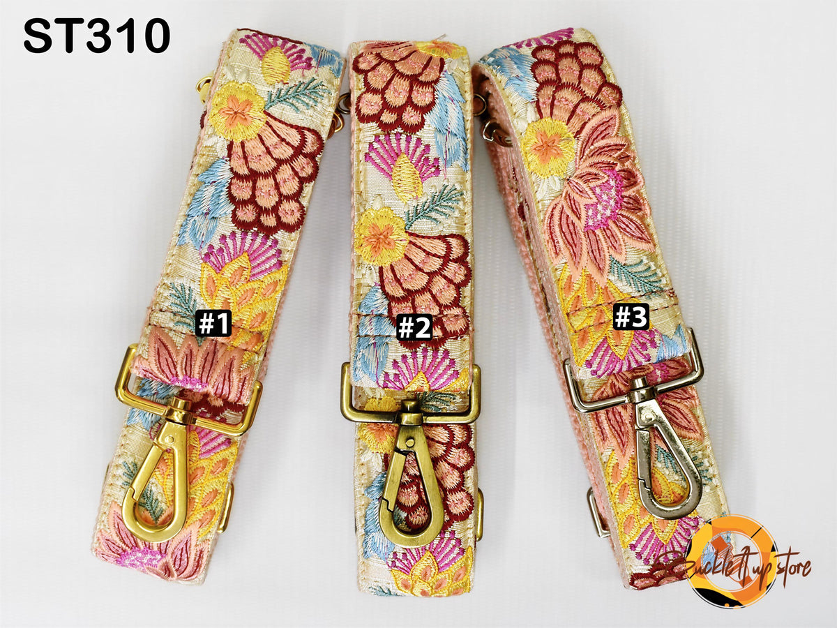 Three colorful floral straps with gold buckles, each with a different number printed on it.