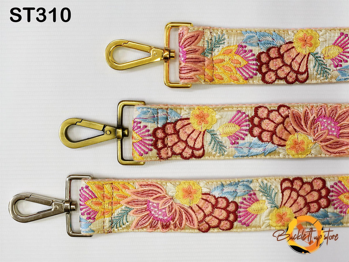 three straps with floral embroidery in different colors, including pink, yellow, and red. The straps have metal buckles and hooks for attaching them to bags or other accessories.