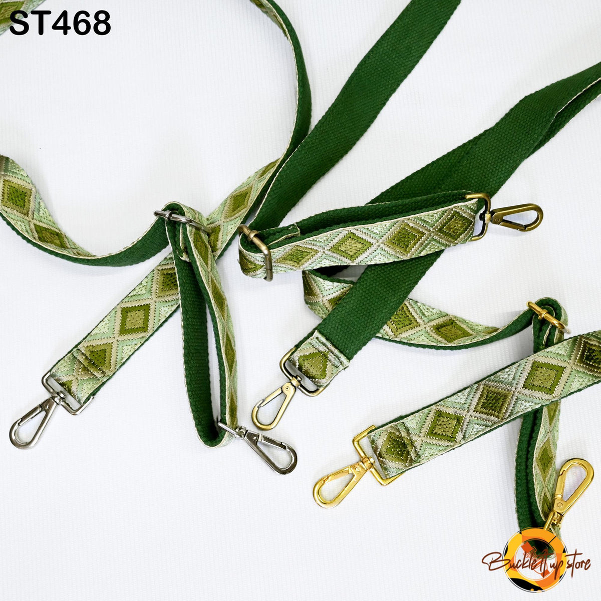 a collection of green and gold patterned straps or straps with metal hooks, arranged on a white background.