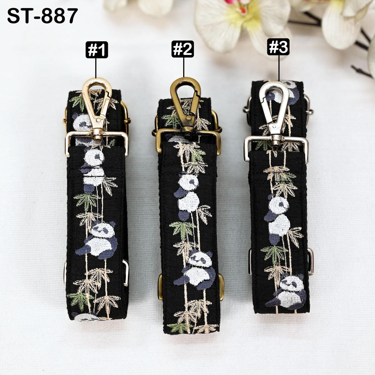 Three panda-themed straps are displayed, each with a unique design and color. The straps are arranged in a row, with the first one being black, the second one being gold, and the third one being silver.