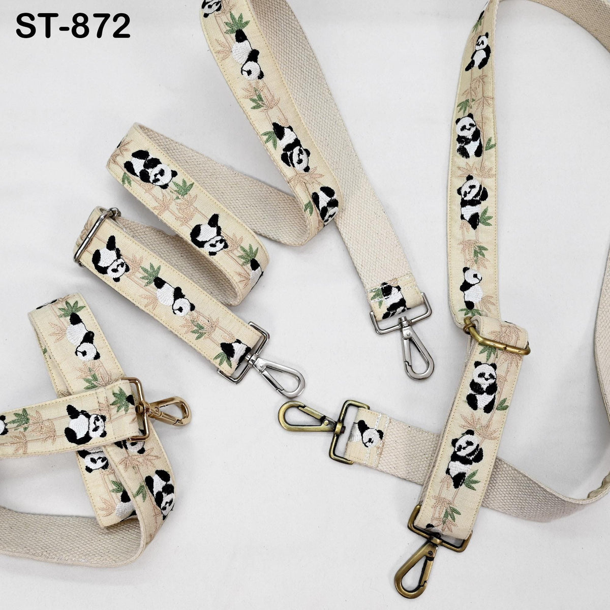 a collection of beige straps adorned with a panda print pattern. The straps are arranged in various positions, with some hanging vertically and others lying horizontally. The panda motif is consistent across all the straps, creating a cohesive and visually appealing design.