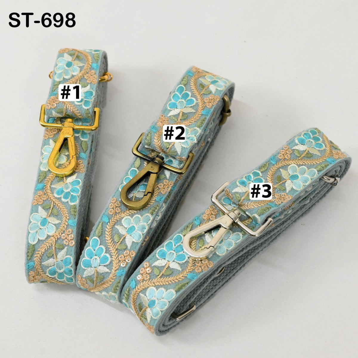 three colorful straps with floral patterns, each with a metal clasp and a label indicating the number.