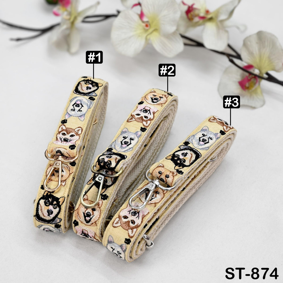 Three leashes with dog faces printed on them, each with a different number indicating the leash number.