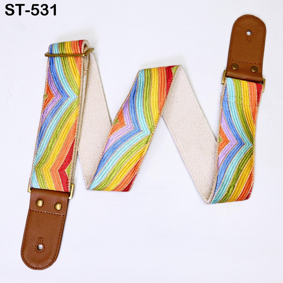 A colorful guitar strap with a pattern of stripes in various colors, including red, orange, yellow, green, blue, and purple. The strap is attached to a brown leather buckle.