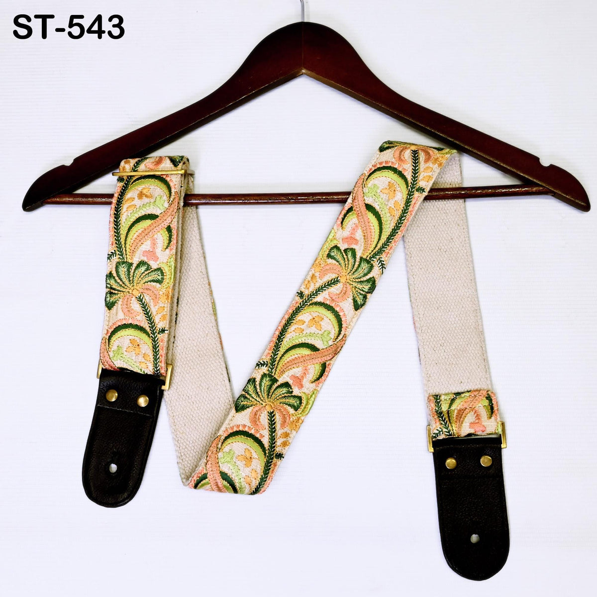A pair of colorful, patterned suspenders hanging on a wooden hanger.