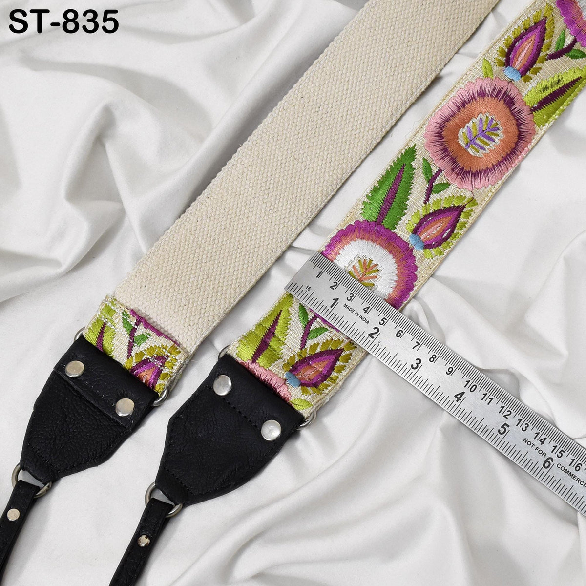 A colorful, patterned strap with a ruler placed next to it, indicating the strap's length.