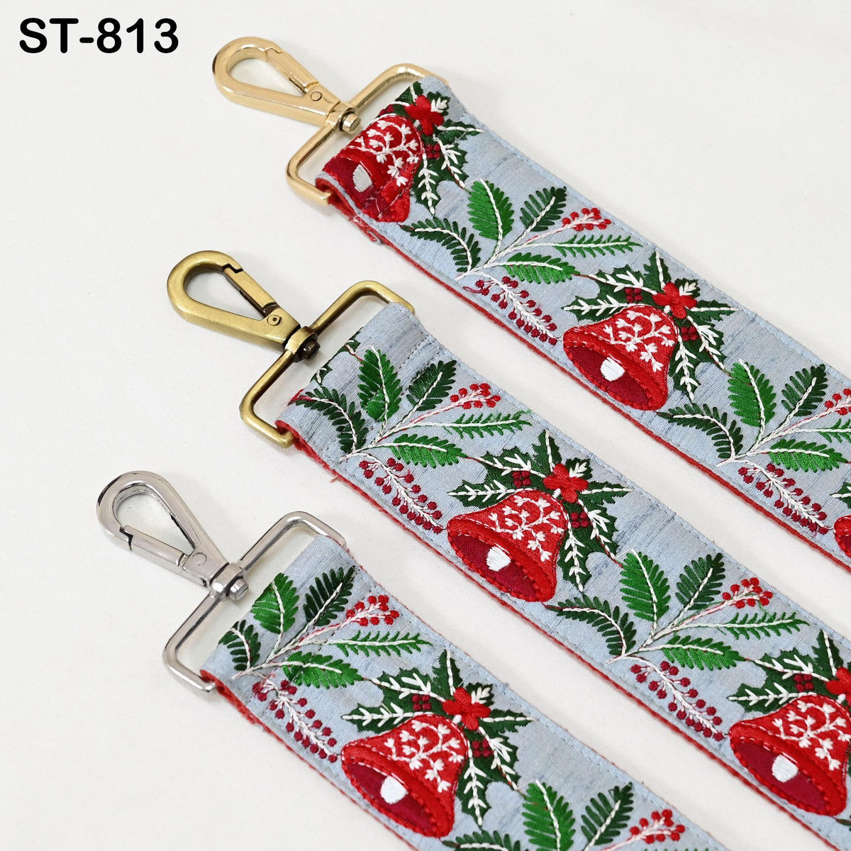 three straps with a festive holiday pattern, featuring red and green leaves, red berries, and a bell motif.