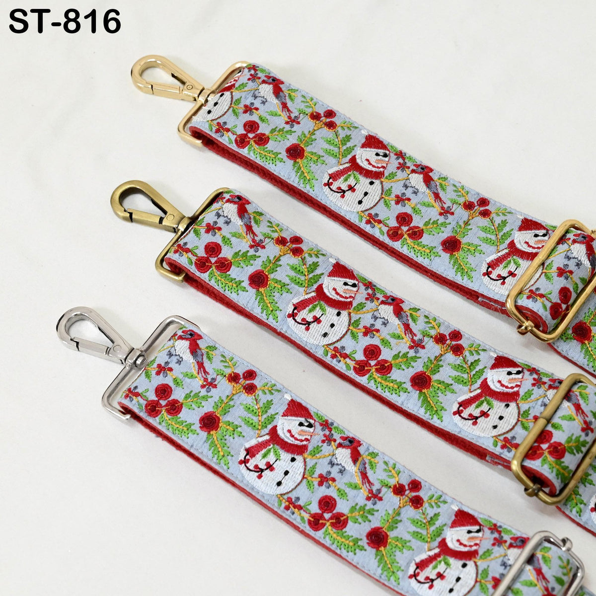three straps with a festive pattern of snowmen and flowers, likely representing Christmas or holiday themes.