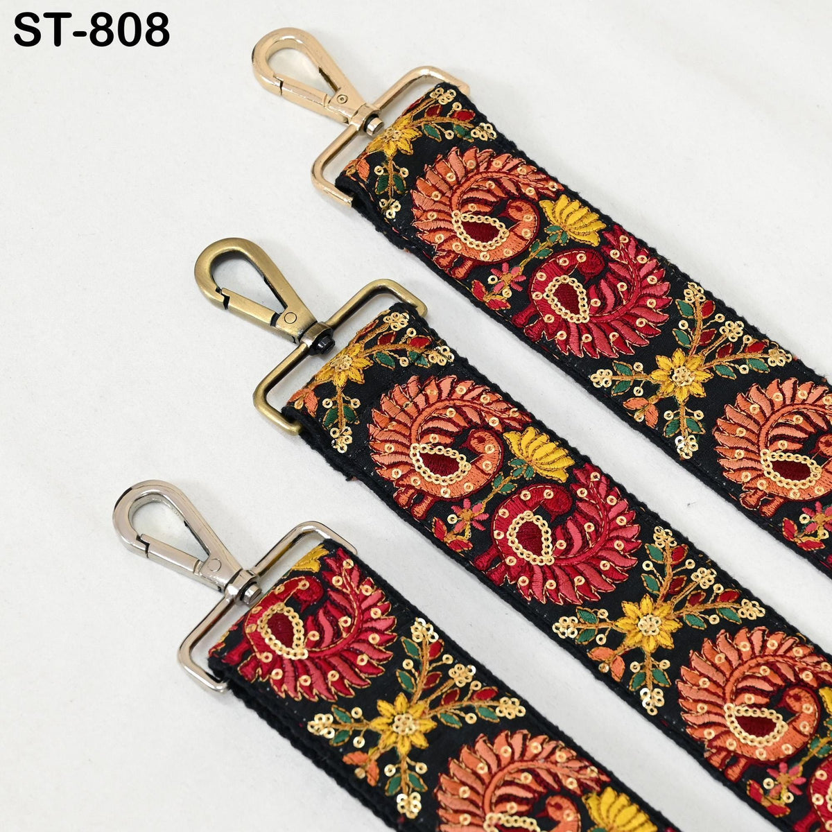 three colorful straps with floral patterns, each featuring a metal clasp and hook.